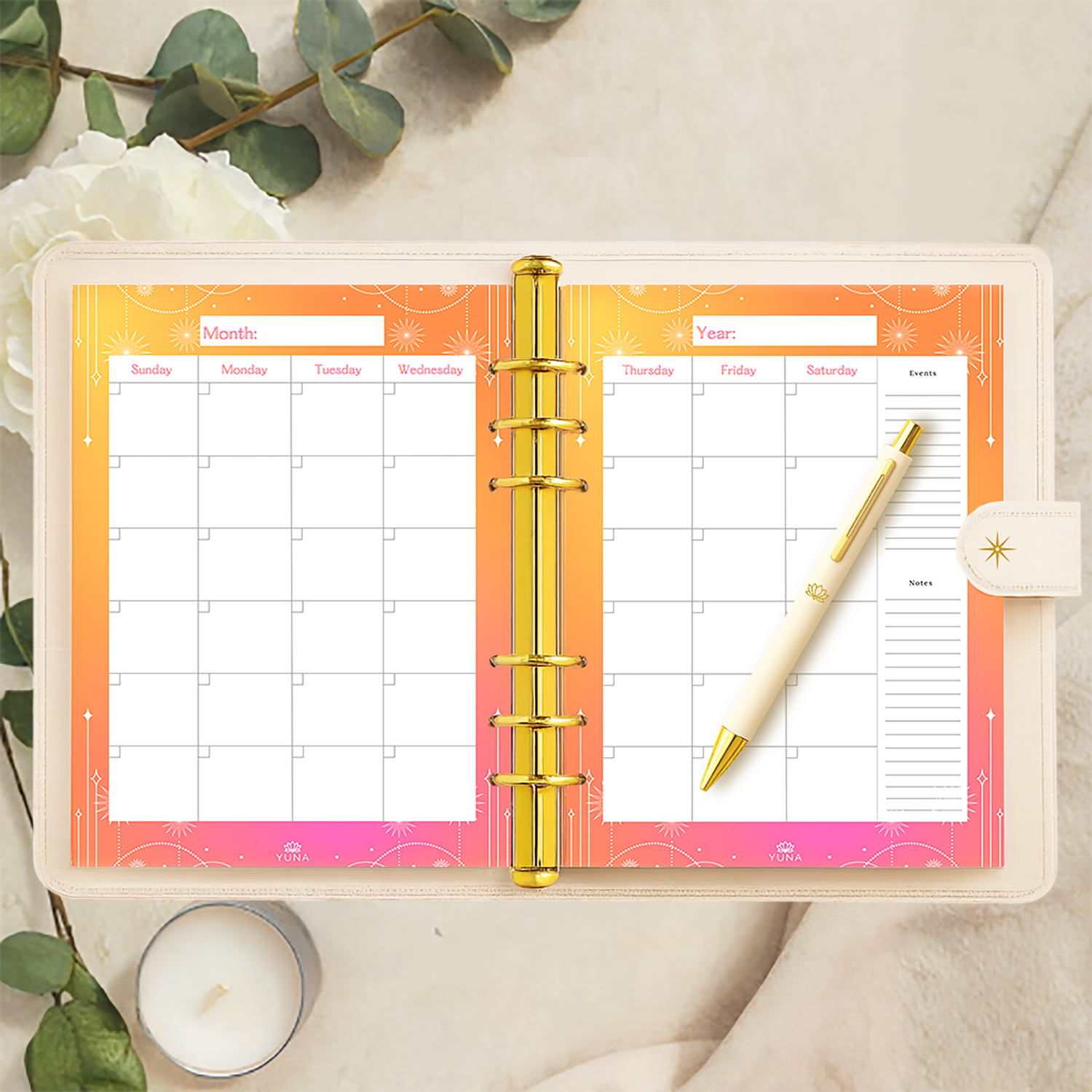 An open planner with a pen on a light surface with decorative elements